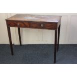 A mahogany two-drawer side table with lion mask handles, on square tapered legs, 94cm