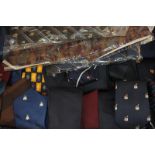 A large collection of gentleman's ties some with crests, possibly universities, owned and worn by