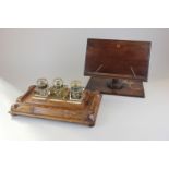An oak desk stand with three glass inkwells, together with a mahogany bookstand