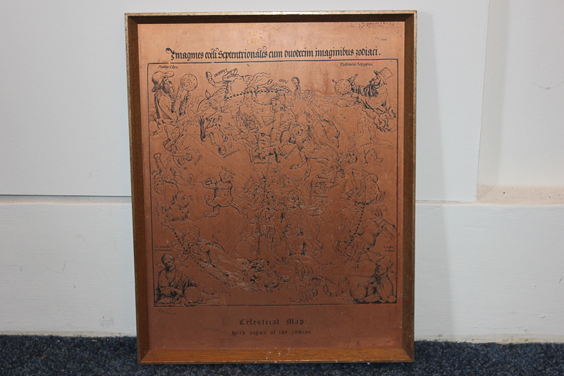 A copper reproduction of a celestial map with signs of the zodiac, framed, 38cm by 29cm, (SPM)