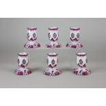 A set of six Continental porcelain candlesticks with pink embellishments, 6.5cm high
