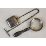 A silver mounted magnifying glass and a silver cased travel watch on chain, (SPM)