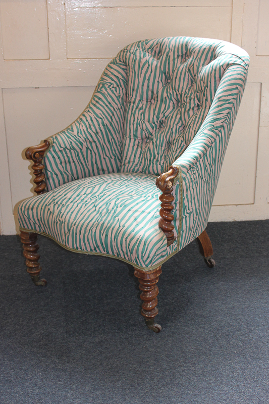 A 19th century walnut framed tub chair with button back, turned supports and legs