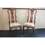 A pair of 18th century Dutch marquetry chairs, one with all-over floral motif, the other of a bird