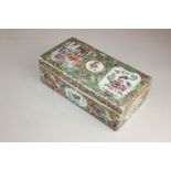 A Chinese Cantonese famille rose porcelain jewellery box decorated with figures in an interior and