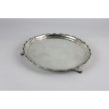 A George VI silver salver with a raised scalloped border, on cabriole paw feet, maker William Hutton