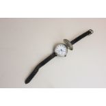 An early silver wristwatch, white enamel, unsigned dial, the movement by Unicorn, screw down case