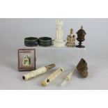 An ivory game token case in the shape of a turret, a pair of cloisonne napkin rings, an ivory