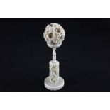 A 19th century Chinese ivory puzzle ball on stand, the ball carved with floral decoration (a/f), the