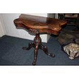 A Victorian walnut serpentine card table on carved baluster support on four scroll legs, 91cm