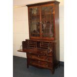 A George III mahogany secretaire bookcase with two glazed doors opening onto three shelves over a