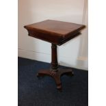 A Victorian rosewood games table with oval baize insert, on rectangular folding swivel top, with one