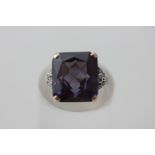 A synthetic alexandrite and diamond dress ring the rectangular cut stone with split shoulders set