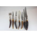An antler handled carving set with a matching pair of fish servers and a similar carving set