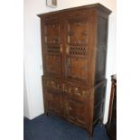 A French oak food cupboard with two panel doors with cutout detailing above two short drawers and