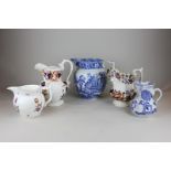 Five various English pottery jugs to include a large blue and white transfer decorated jug, 22cm