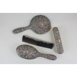 An Elizabeth II silver backed dressing table set of hairbrush, hand mirror, clothes brush and