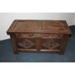 A 18th century oak coffer with carved panel front, 101cm