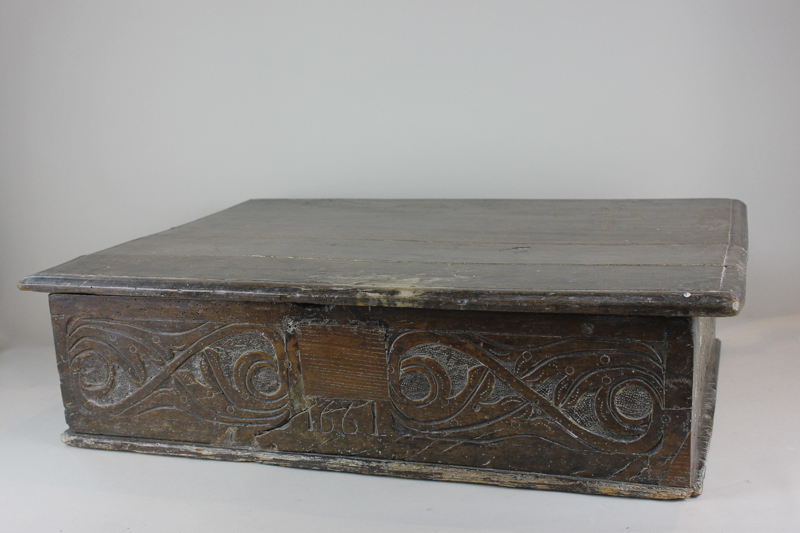 A 17th century oak lace box with hinged top and carved sides, dated 1661 (wormed) 64cm (NC)