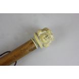 A 19th century ivory cane handle modelled as the face of a chorister, later mounted onto an