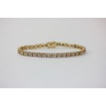 A diamond bracelet strung with four stone clusters in 18ct yellow gold