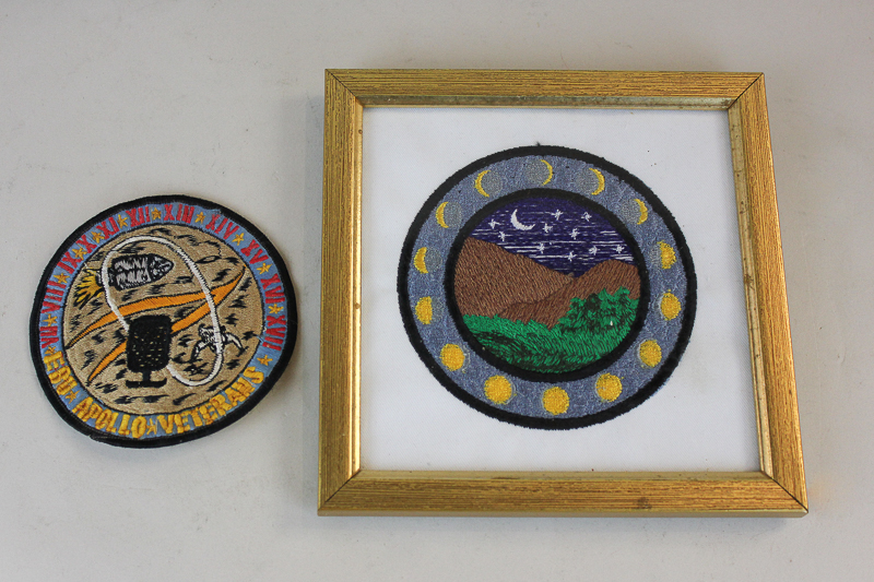 A circular embroidered cloth badge, EBU Apollo Veterans, and another similar badge in a glazed frame