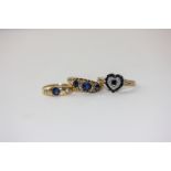 A heart-shaped sapphire cluster ring; a sapphire and diamond three stone ring and a three stone