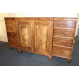 A 19th century mahogany breakfront linen cupboard with centre cupboard with sliding trays enclosed