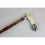 A early 20th century ivory and unmarked silver handled walking stick