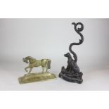 A cast iron doorstop of a seated dog, together with another brass doorstop of a horse, W & P mark to