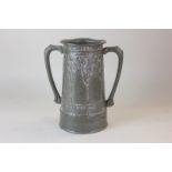 An Arts and Crafts pewter two-handled mug decorated with stylized trees, inscribed For Old Time's