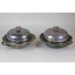 A pair of 19th century silver plated muffin warming dishes with floral scrollwork edges and flower