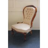 A Victorian walnut framed button back chair on cabriole legs and castors