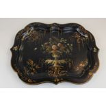 A Russian papier mache black lacquer tray with floral centrepiece and gilt borders, indistinct