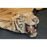 A Rowland Ward, early 1940's tiger skin rug, tanned and lined, the label under the chin titled The