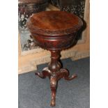 A Victorian walnut circular work table with floral carved  tripod support, 43cm