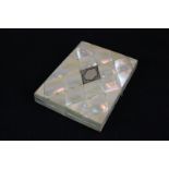 A Victorian mother of pearl purse with diamond shaped interlocked pieces around central 'silver'