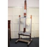 A large mahogany artist's easel, 81cm by 256cm (NC)