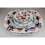 A large imperial stone china platter with two matching small serving platters and two plates,