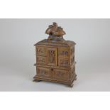 A Black Forest carved wood jewellery casket with floral designs with game bird finial and unusual