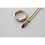 A 9ct three colour gold ring, 2.9g; a small ruby and diamond pendant on a gilt metal chain