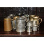 A large collection of pewter mugs, some with commemorative inscriptions, including The Sky at Night,