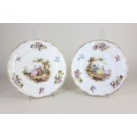 A pair of German Damm porcelain cabinet plates decorated with scenes of lovers and gilt