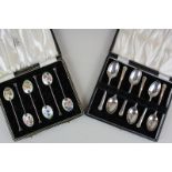 A cased set of Elizabeth II silver coffee spoons with floral enamel backs, Birmingham 1957, together