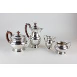 A silver plated four piece tea set of teapot, hot water jug, sugar bowl and milk jug with plain