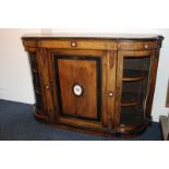 A Victorian walnut credenza decorated with banded wood, the central panel door enclosing one shelf