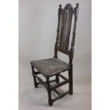 An 18th century oak high back chair with arched back and turned supports, with later oak seat (a/f),