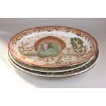 A Florentine oval serving platter, the border decorated with mythical creatures, together with two