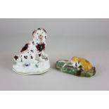Two Staffordshire pottery dog figurines of a spaniel and a greyhound