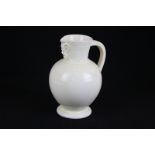 A Wedgwood mask head jug with cream glaze, 15cm high